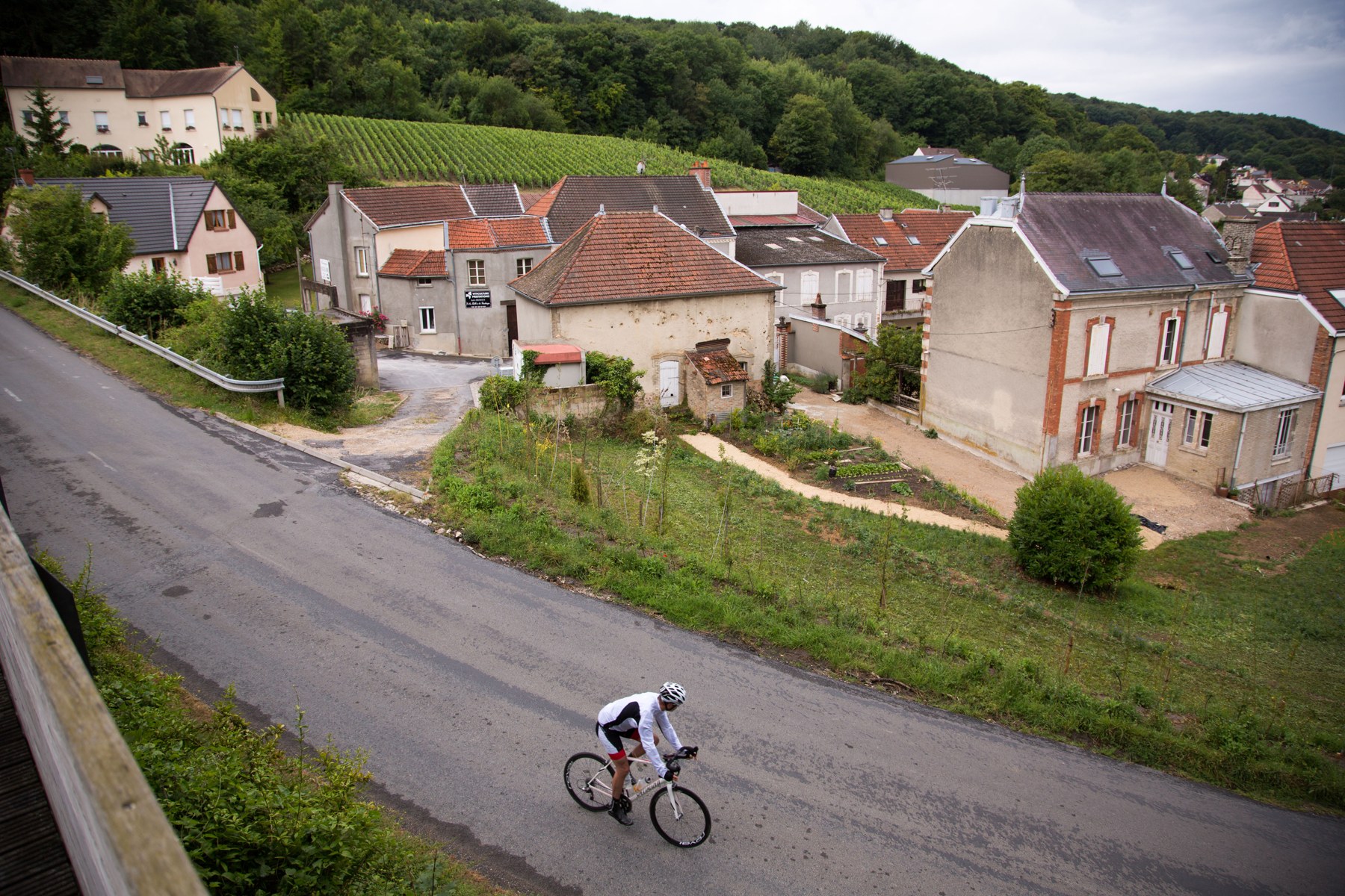 A cyclist riding through a French village