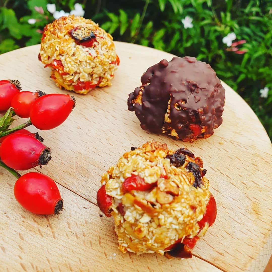 No-bake rosehip protein balls with oats and seeds on a wooden board